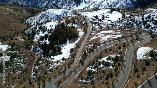 Dynamic Aerial View of Mountain Road with Rising Camera Movement