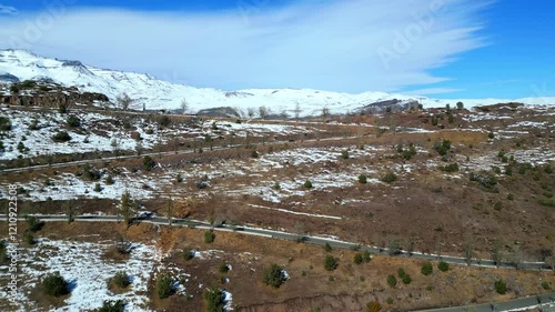 Aerial Panorama of Winding Road Across Snowy Plateau