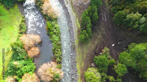 Aerial View of a Serene River Flowing Through Lush Greenery