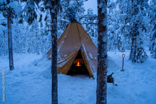 Obraz na plátně In the snowy forest of Swedish Lapland stands a serene Sami tent