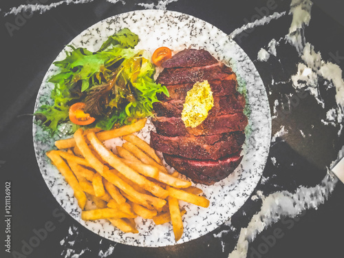 RIBEYE STEAK 300g signature Australian ribeye with mixed salad, fries with garlic butter sauce.