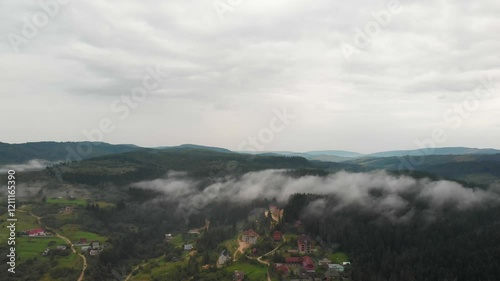 Magnificent Aerial View Of Mountains And Dense Forests Under Dark Clouds, With Raindrops Falling, Creating A Dramatic And Serene Atmosphere In A Remote Natural Landscape.
