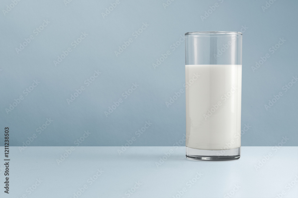 Glass of milk, blue background Glass of milk, blue background
