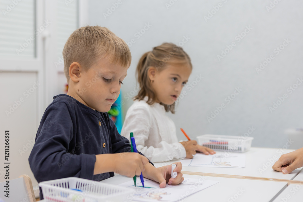 children with a teacher at a kindergarten class children with a teacher at a kindergarten class