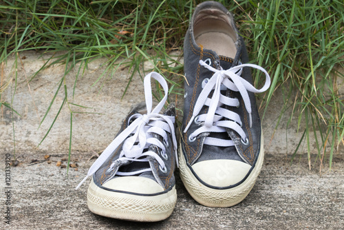 black sneakers shoes of lifestyle arragement flat lay style on cement floors