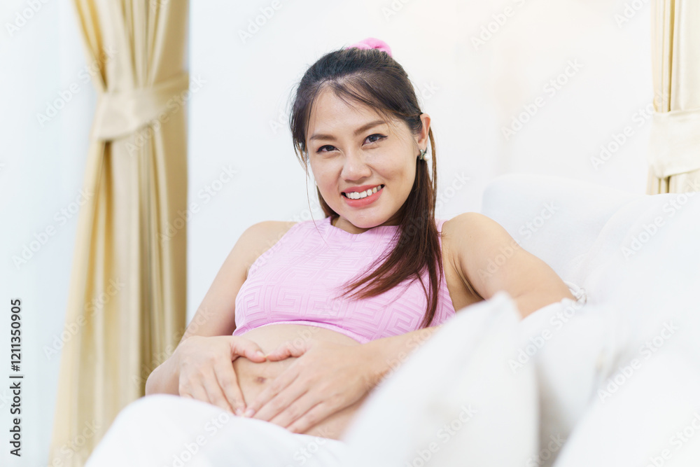Asian pregnant woman relaxing at home. Asian pregnant woman relaxing at home.