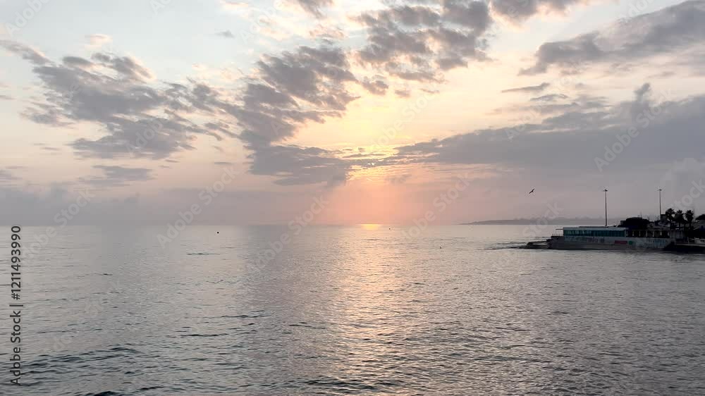 Romantic sunrise skyline clouds filled sky start of day sun peak over ocean