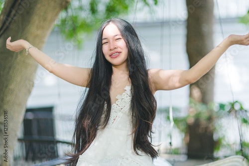 Free Download Cheerful Young Woman Enjoying a Sunny Day in a Natural Setting - GFXLoad