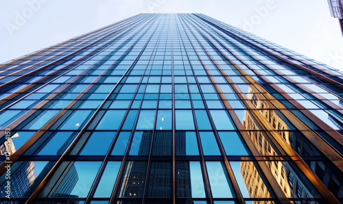 The fa ç ade of modern skyscrapers and glass curtain wall buildings in the city photo