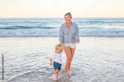 Mother and son playing in shallow water on Gold Coast beach