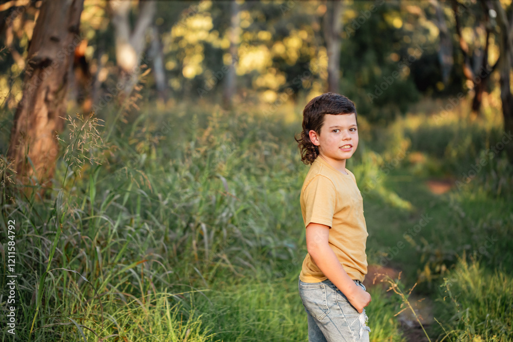 Portrait of happy boy wearing yellow shirt in Australian country bush setting Portrait of happy boy wearing yellow shirt in Australian country bush setting