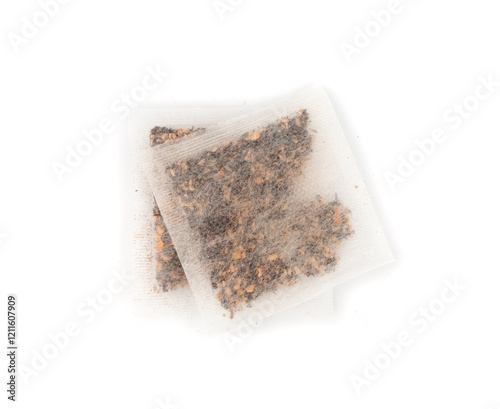 Dry black tea bag with hibiscus, fruits isolated. Raspberry seeds red tea sachet, herbal drink photo