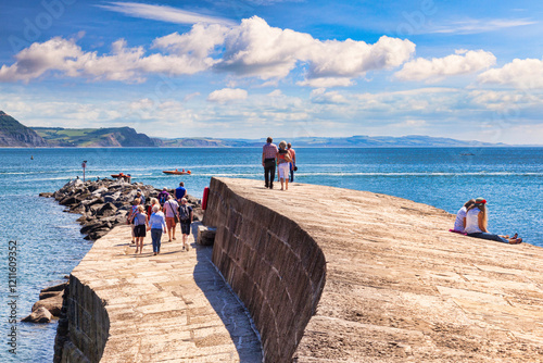 Lyme Regis, Dorset, England, UK - Visitors enjoying the good weather on The Cobb. photo
