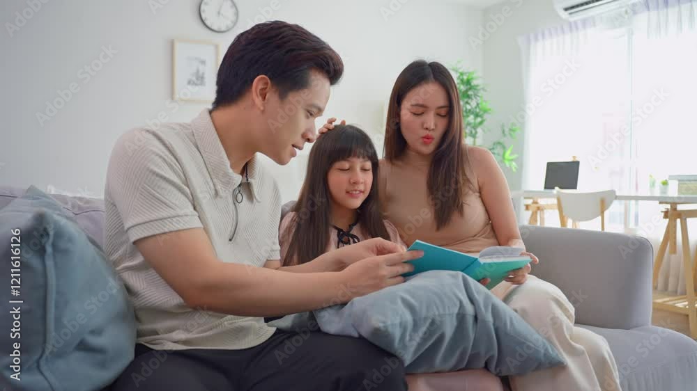 Asian parents spend leisure time with young daughter in living room at home Asian parents spend leisure time with young daughter in living room at home