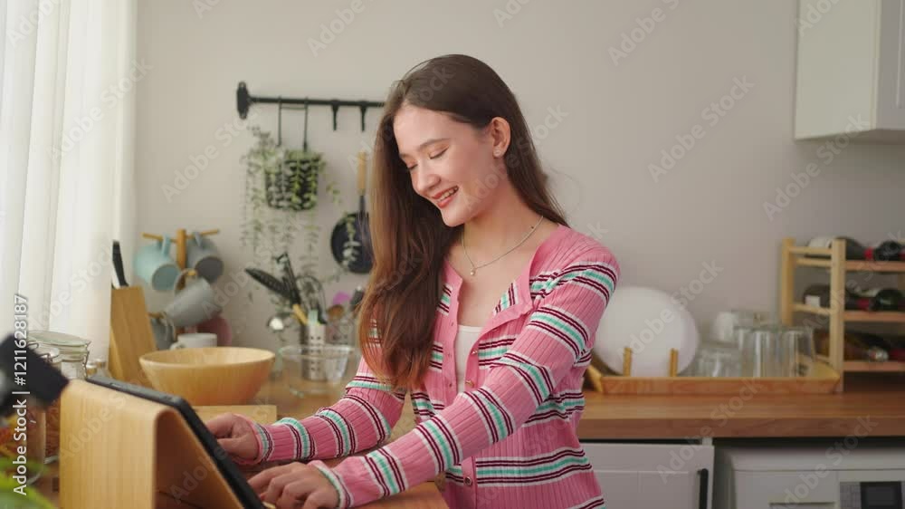 Asian young woman using digital tablet browse social media in house. Asian young woman using digital tablet browse social media in house.