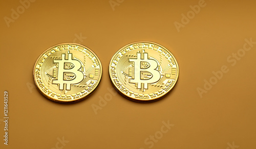 Two golden  bitcoin coins isolated on light brown background web design finance banking investment blockchain technology 