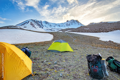 Camping adventure in a breathtaking mountain landscape under a vibrant sky