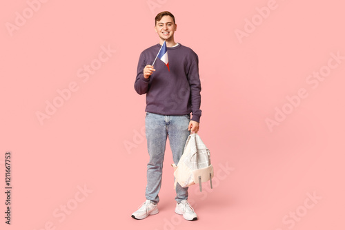 Smiling young man holding f...