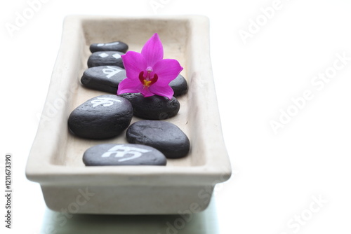 spa stones and orchid on a tray