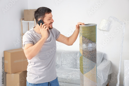 Young man with rolled carpe...