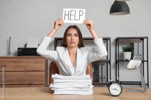 Tired businesswoman holding...