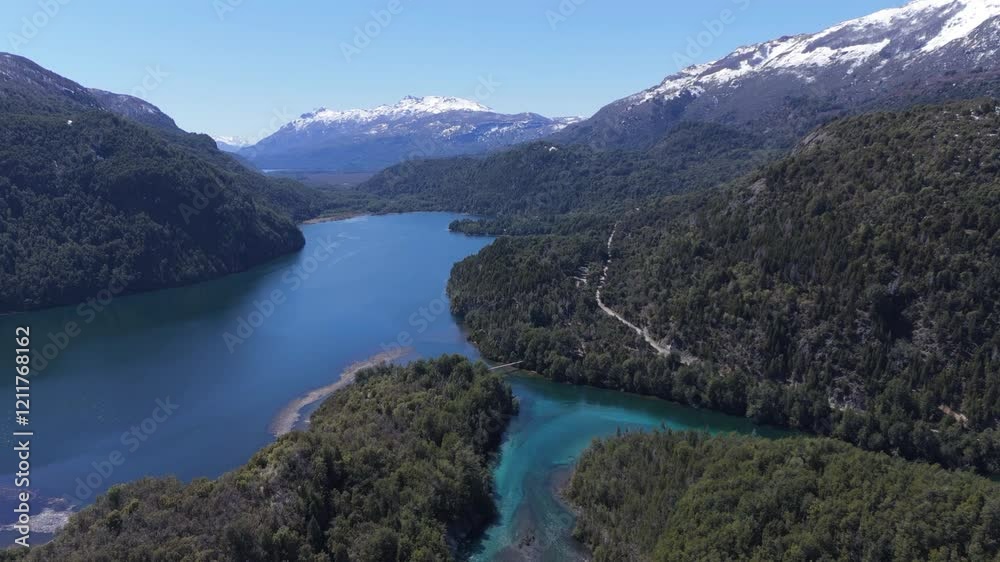 Downward aerial movement of a serene mountain lake surrounded by forest at Parque Nacional Los Alerces, Patagonia, Argentina. Downward aerial movement of a serene mountain lake surrounded by forest at Parque Nacional Los Alerces, Patagonia, Argentina.