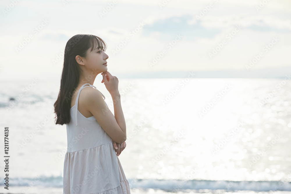 海辺を散策する若い女性