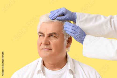 Doctor examining senior man...