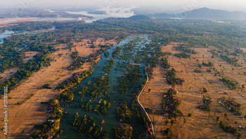 Aerial sunset landscape in Mekong River, Laos 4000 Islands, reflection in traditional tropical Village