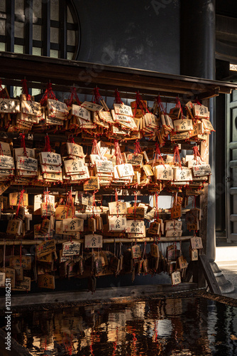 Tokyo Japan - January 13 2025: sunshine on the Japanese wooden signs (Ema) which hanging at the Yushima Seido shrine in Tokyo city at daytime in Japan. photo