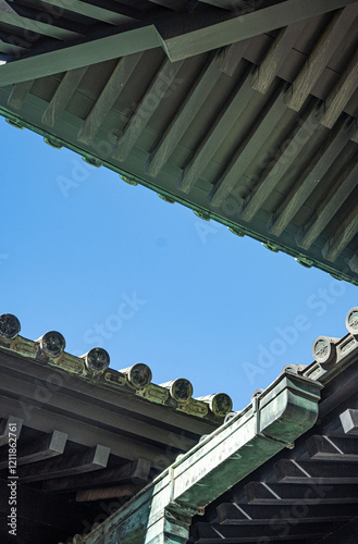 Japanese temple, the roof of the Yushima Seido temple in Bunkyo city with blue sky with space for text at daytime in the winter in Tokyo in Japan. photo