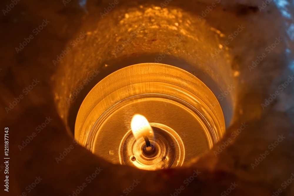 A candle shines in the dark. Himalayan salt candlestick. View from above. A candle shines in the dark. Himalayan salt candlestick. View from above.