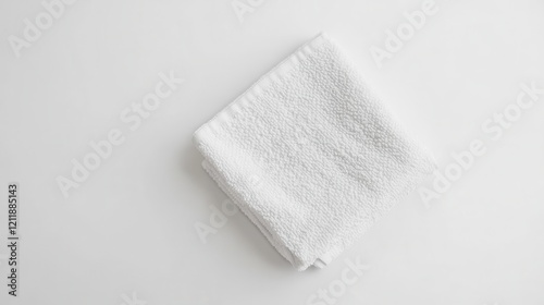 Neatly Folded Small White Washcloth on Surface