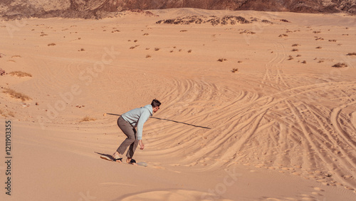 man sandboarding colored canyon in the Sinai desert in Egypt