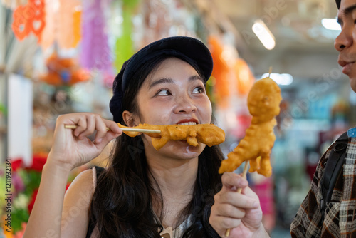 Friends engaging in playful banter over street food, sharing crispy snacks while traveling in a vibrant market