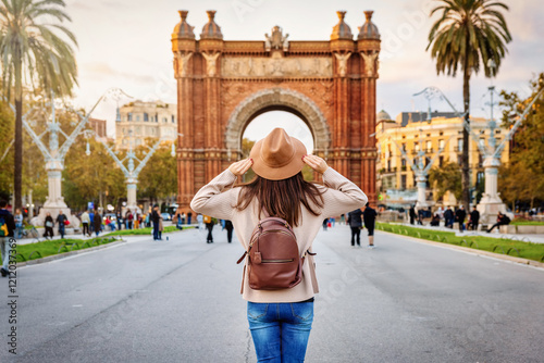 Photography A tourist woman stands in front of the famous Triumph Arch in Barcelona, Spain,