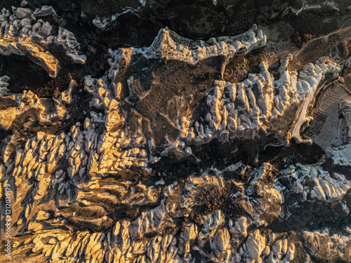 Obraz na płótnie Aerial view of the otherworldly landscape of gorges, canyons, and volcanic rock formations in Cappadocia at sunset w salonie