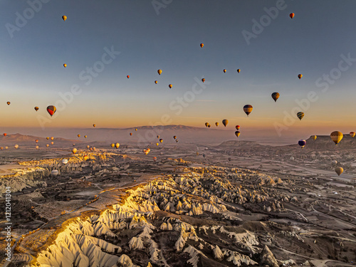 Obraz na płótnie Hundreds of hot air balloons above Love Valley with tall chimney-like rock formations in Cappadocia at sunrise w salonie