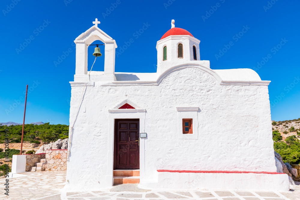 White Chapel of Agia Kyriaki with small red dome, on top of a cliff, near Pigadia, Karpathos island, Greece White Chapel of Agia Kyriaki with small red dome, on top of a cliff, near Pigadia, Karpathos island, Greece