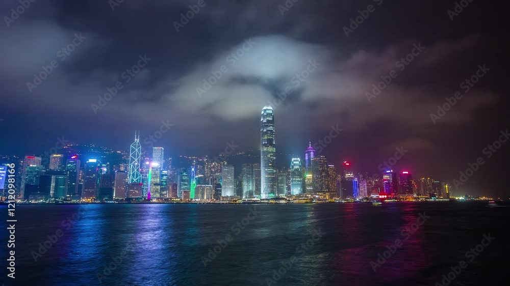 HONG KONG, CHINA - JANUARY 11, 2025: Stunning skyline view over Victoria Harbour with colorful lights reflecting on water HONG KONG, CHINA - JANUARY 11, 2025: Stunning skyline view over Victoria Harbour with colorful lights reflecting on water