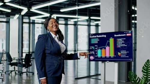 Wallpaper Mural Businesswoman presents financial data in modern office setting during corporate meeting Torontodigital.ca