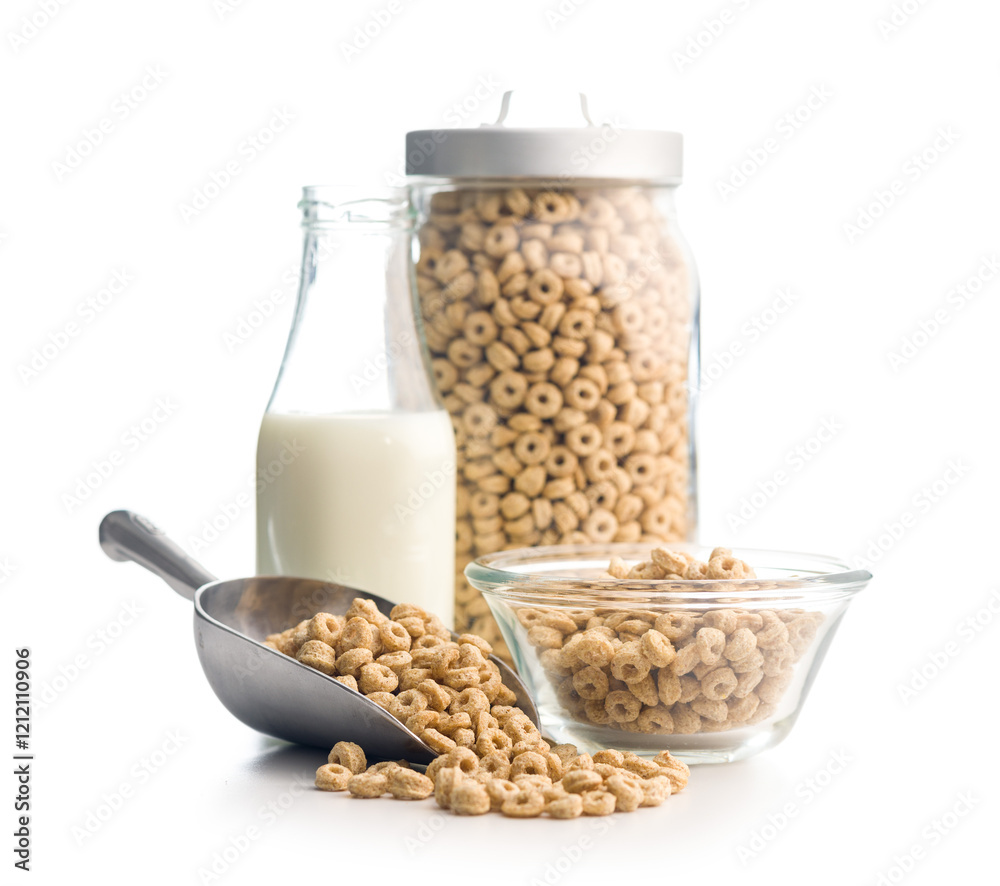 Sweet honey cereal rings in scoop and milk isolated on white background. Sweet honey cereal rings in scoop and milk isolated on white background.