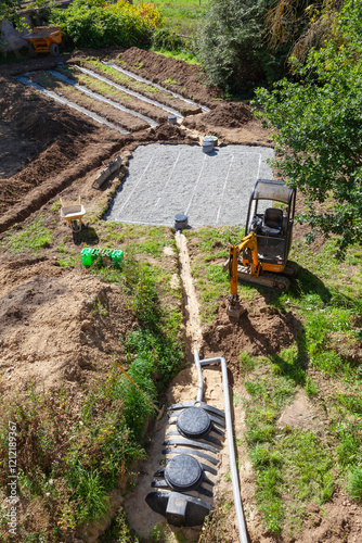 New household septic tank installation with primary and secondary sand and gravel filter beds viewed from above showing layout of the system