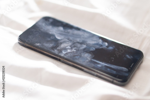 Close-up of a Smudged Smart phone on Soft Surface