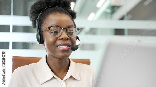 African american female corporate operator in headset working in customer support service on helpline telesale talking using laptop in business office. Agent of call center advises client. Close up