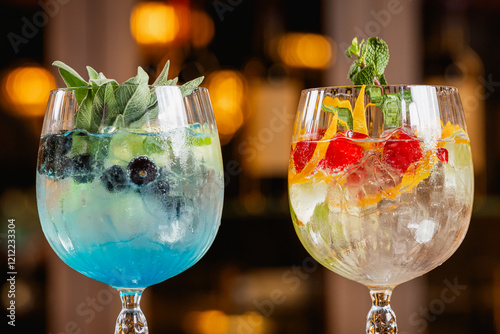 Fototapeta Naklejka Na Ścianę i Meble -  Gin drinks. Different kind of long drinks gin made with fruits like blueberries, raspberry and lime. Delicious gin cocktails drink with alcohol.