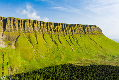 Aerial view of Benbulbin, aka Benbulben or Ben Bulben, iconic landmark, large flat-topped nunatak rock formation. Magnificent costal driving route view at Wild Atlantic Way, Ireland.