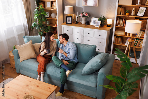 Couple having fun drinking coffee and relaxing at home