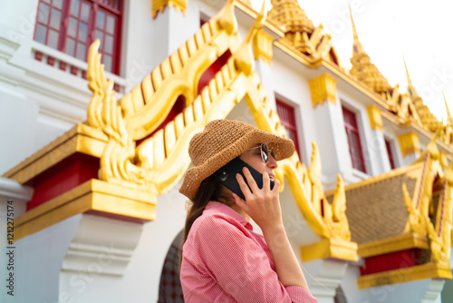 Beautiful caucasiann women use smartphone while travel in temple photo