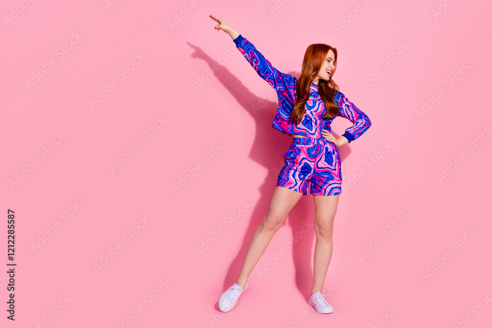 Full body portrait of pretty young girl dance point finger wear pullover isolated on pink color background